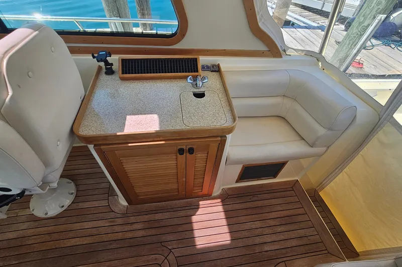  Yacht Photos Pics Interior of 2009 Sabre 42 Express yacht with seating and compact kitchenette.