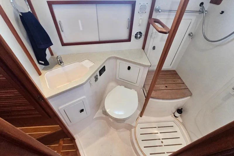  Yacht Photos Pics 2009 Sabre 42 Express yacht bathroom with sink, toilet, and shower area.