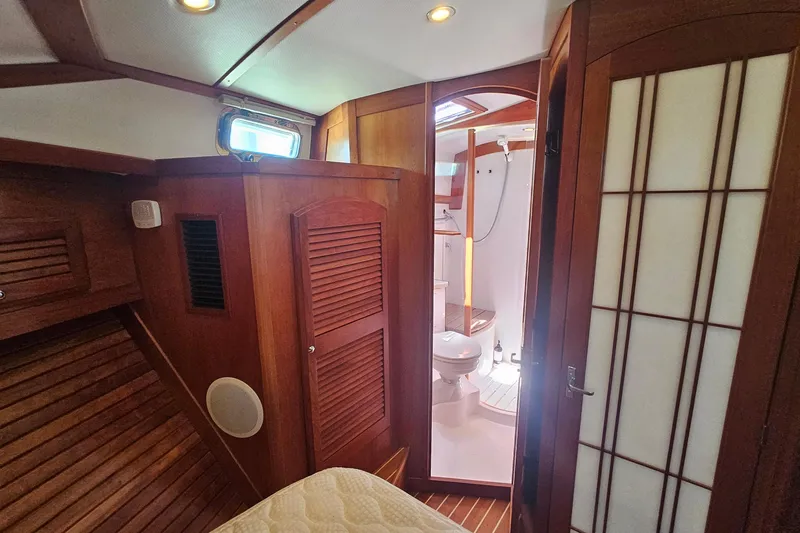  Yacht Photos Pics 2009 Sabre 42 Express yacht interior with wooden finish and compact bathroom.