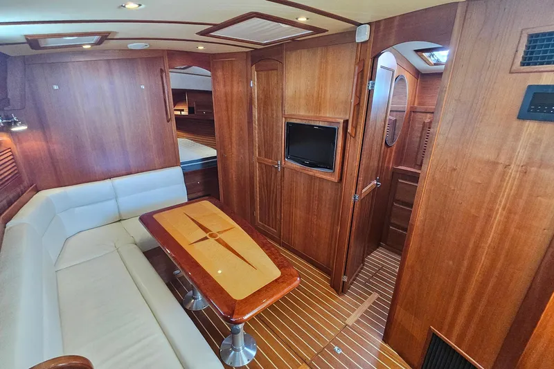  Yacht Photos Pics Luxurious 2009 Sabre 42 Express yacht interior with wood finish and cozy seating area.