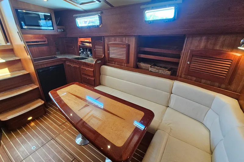  Yacht Photos Pics Luxurious interior of 2009 Sabre 42 Express yacht with elegant wood finishes and cozy seating.