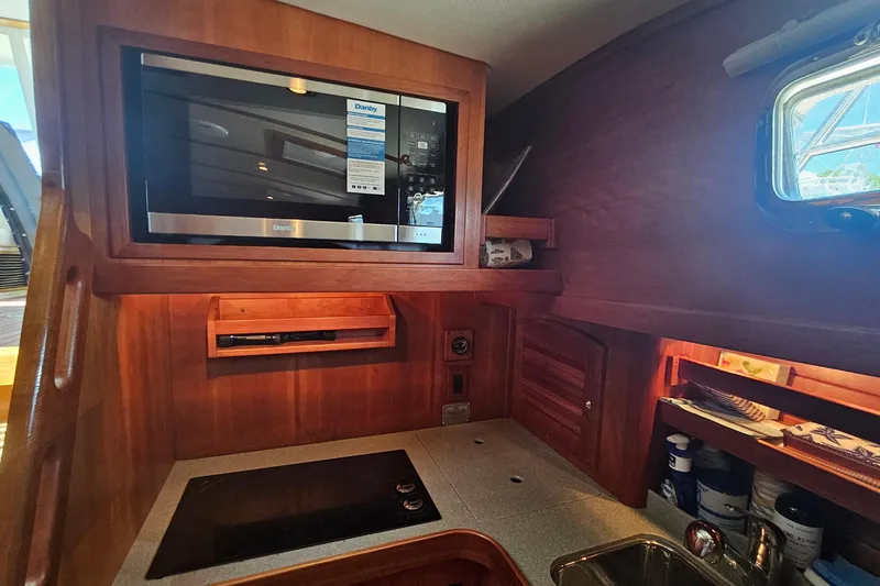  Yacht Photos Pics 2009 Sabre 42 Express yacht interior with microwave and stove in wooden galley.