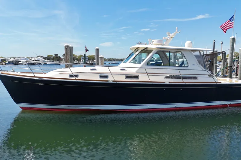  Yacht Photos Pics 2009 Sabre 42 Express yacht docked in a marina under clear blue skies.