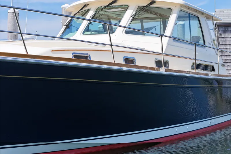  Yacht Photos Pics 2009 Sabre 42 Express yacht docked, featuring sleek design and elegant navy hull.