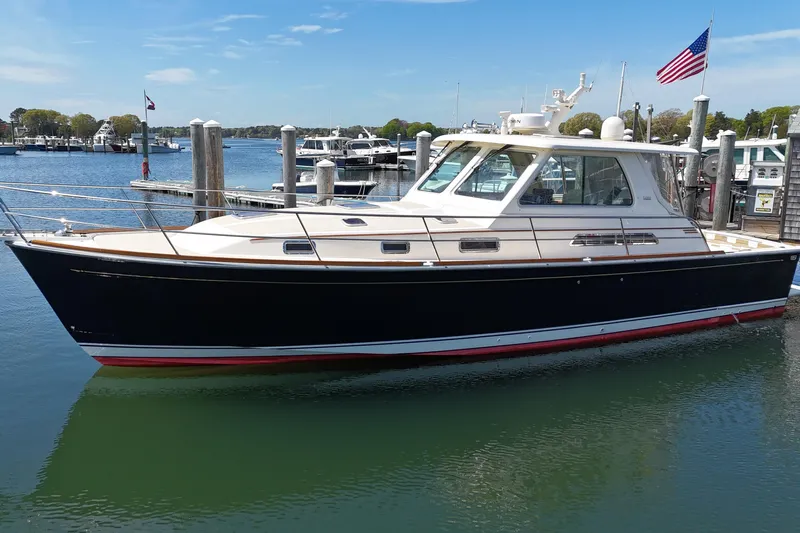  Yacht Photos Pics 2009 Sabre 42 Express yacht docked in a marina, featuring sleek design and American flag.