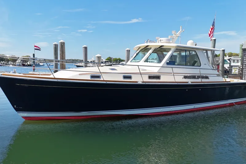  Yacht Photos Pics 2009 Sabre 42 Express yacht docked in a marina, under a clear blue sky.