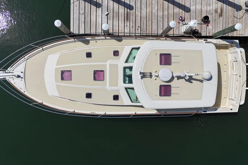  Yacht Photos Pics Overhead view of a 2009 Sabre 42 Express yacht docked at a wooden pier.