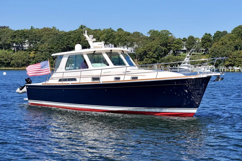  Yacht Photos Pics 2009 Sabre 42 Express yacht on water, American flag, scenic background.