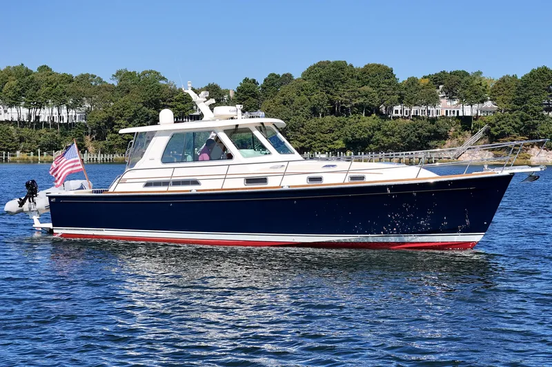  Yacht Photos Pics 2009 Sabre 42 Express yacht cruising on a sunny day with American flag.