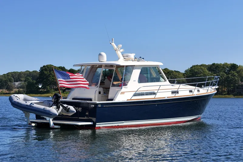  Yacht Photos Pics 2009 Sabre 42 Express yacht on calm water with American flag.