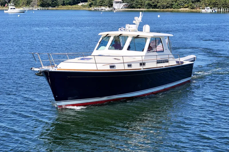  Yacht Photos Pics 2009 Sabre 42 Express yacht cruising on a serene blue lake.