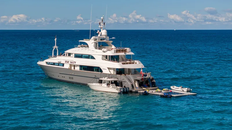 Stay Salty Yacht Photos Pics Luxury yacht Horizon Premier 135, 2010 model, anchored in clear blue ocean.