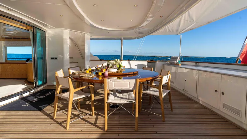 Stay Salty Yacht Photos Pics Luxurious yacht deck with dining table, ocean view; Horizon Premier 135, 2010 model.