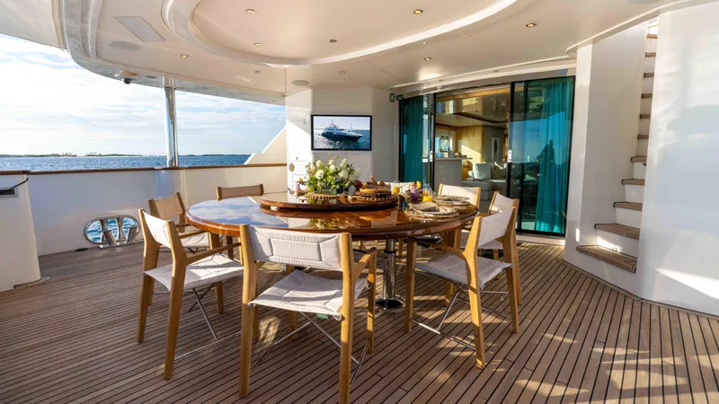 Stay Salty Yacht Photos Pics Luxurious yacht deck with dining area, Horizon Premier 135, 2010 model, ocean view.
