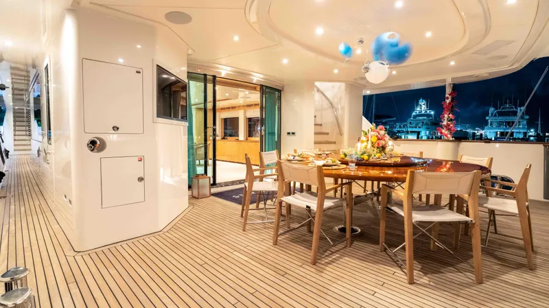 Stay Salty Yacht Photos Pics Luxurious yacht deck dining area with elegant table setting, Horizon Premier 135, 2010 model.