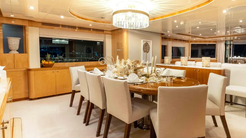 Stay Salty Yacht Photos Pics Luxurious dining area on 2010 Horizon Premier 135 yacht, featuring elegant decor and ambient lighting.