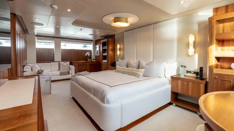 Stay Salty Yacht Photos Pics Luxurious yacht bedroom with modern decor, featuring a spacious bed and elegant lighting.
