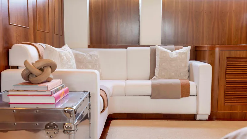 Stay Salty Yacht Photos Pics Luxurious yacht interior with white sofa, decorative pillows, and wooden paneling, Horizon Premier 135, 2010.