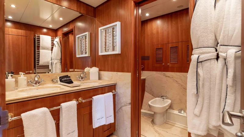 Stay Salty Yacht Photos Pics Luxurious yacht bathroom with wooden accents, marble surfaces, and plush towels, Horizon Premier 135, 2010.