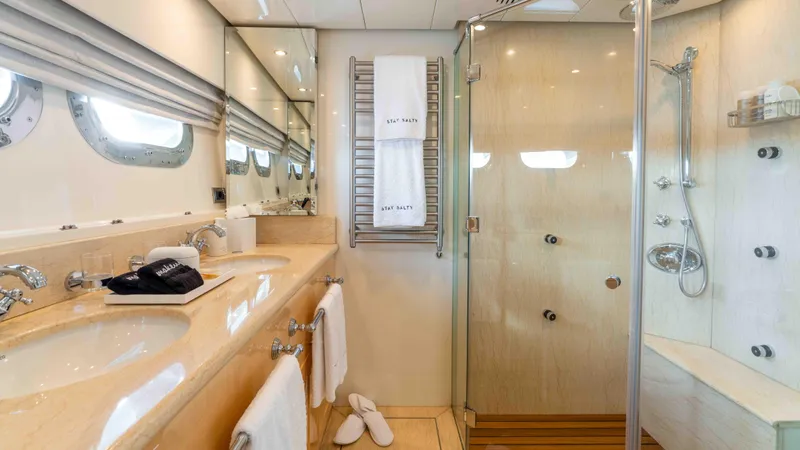 Stay Salty Yacht Photos Pics Luxurious yacht bathroom with dual sinks, glass shower, and elegant fixtures on Horizon Premier 135.