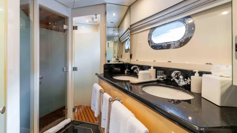 Stay Salty Yacht Photos Pics Luxurious yacht bathroom with dual sinks, modern fixtures, and porthole window, Horizon Premier 135, 2010.