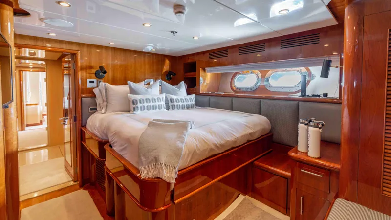 Stay Salty Yacht Photos Pics Luxurious bedroom interior on 2010 Horizon Premier 135 yacht with elegant wood finishes.