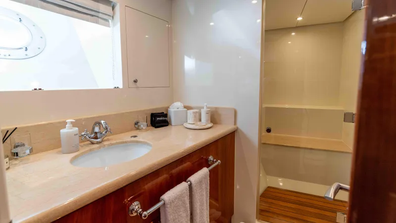 Stay Salty Yacht Photos Pics Luxurious bathroom in 2010 Horizon Premier 135 yacht with modern fixtures and wooden accents.