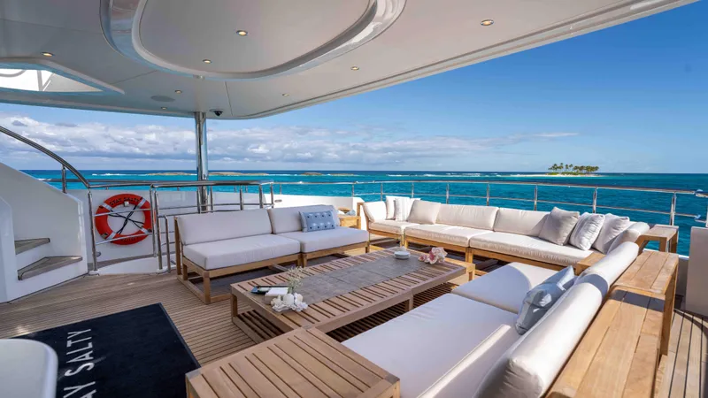 Stay Salty Yacht Photos Pics Luxurious Horizon Premier 135 yacht deck with ocean view, featuring elegant outdoor seating, 2010 model.