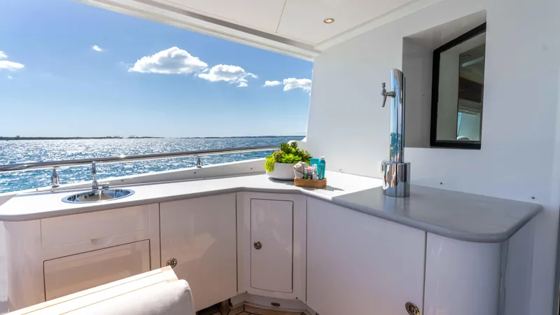 Stay Salty Yacht Photos Pics Luxurious yacht deck with bar area, Horizon Premier 135, ocean view, sunny day.