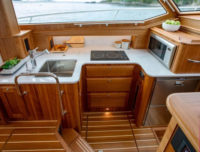 Call For Availability Yacht Photos Pics 2025 Sabre 43 Salon Express yacht kitchen with modern appliances and wooden cabinetry.