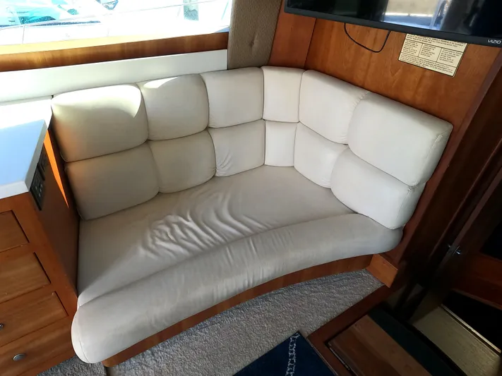  Yacht Photos Pics 2002 Luhrs 34 Convertible boat interior with beige cushioned seating.