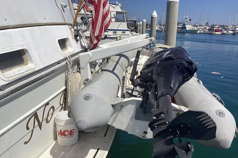 No Reservations Yacht Photos Pics 1984 Spindrift 52 Motor Yacht with dinghy and outboard motor at marina.