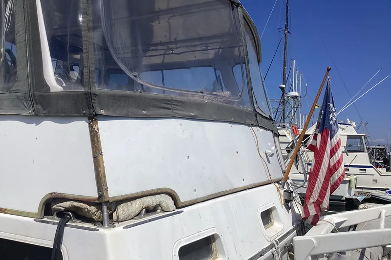 No Reservations Yacht Photos Pics 1984 Spindrift 52 Motor Yacht with American flag at marina.