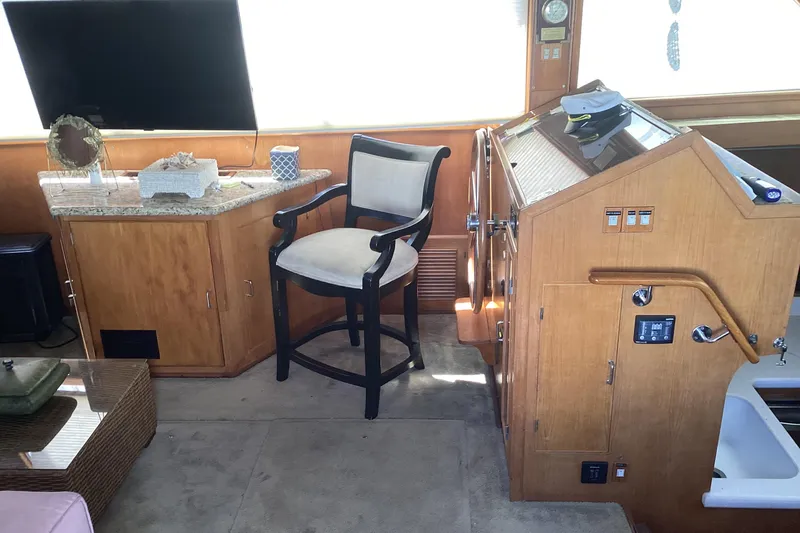 No Reservations Yacht Photos Pics Interior of 1984 Spindrift 52 Motor Yacht with helm, chair, and TV.
