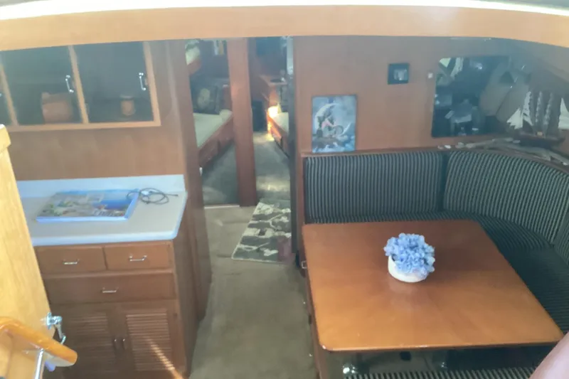 No Reservations Yacht Photos Pics Interior of 1984 Spindrift 52 Motor Yacht with dining area and cabinetry.