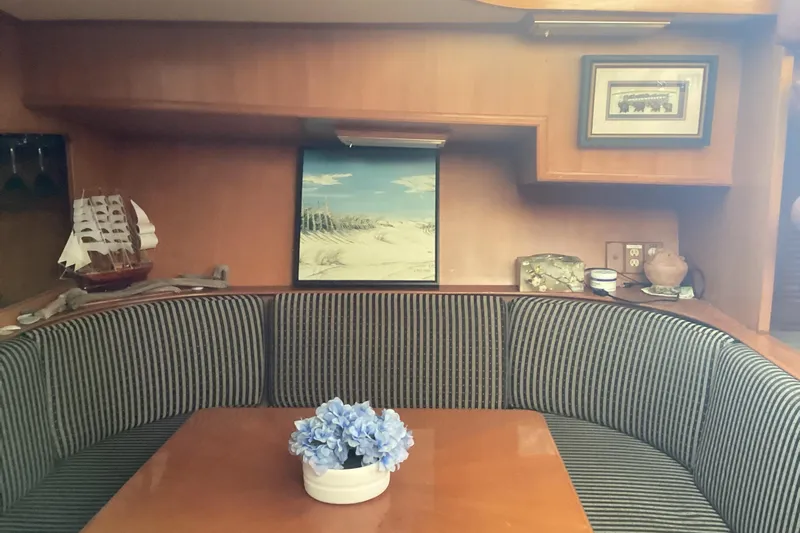 No Reservations Yacht Photos Pics Interior of 1984 Spindrift 52 Motor Yacht with striped seating and nautical decor.