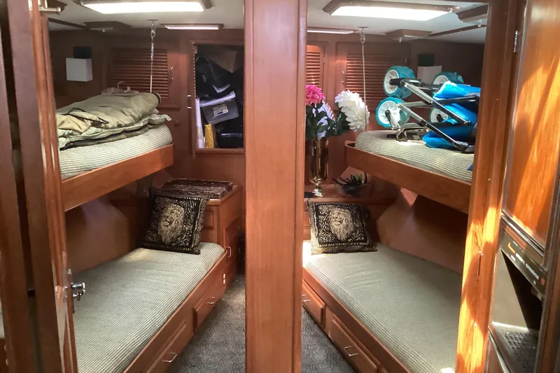No Reservations Yacht Photos Pics 1984 Spindrift 52 Motor Yacht interior with cozy twin bunk beds and wooden cabinetry.