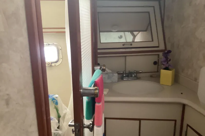No Reservations Yacht Photos Pics Bathroom interior of 1984 Spindrift 52 Motor Yacht with sink and mirror.
