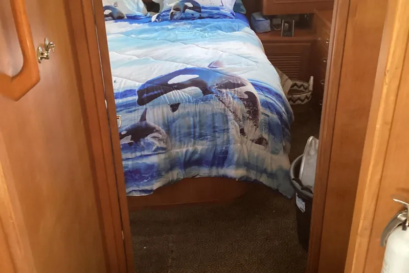 No Reservations Yacht Photos Pics Cozy bedroom in 1984 Spindrift 52 Motor Yacht with orca-themed bedding.