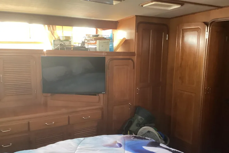 No Reservations Yacht Photos Pics Interior of 1984 Spindrift 52 Motor Yacht with wood cabinetry and mounted TV.