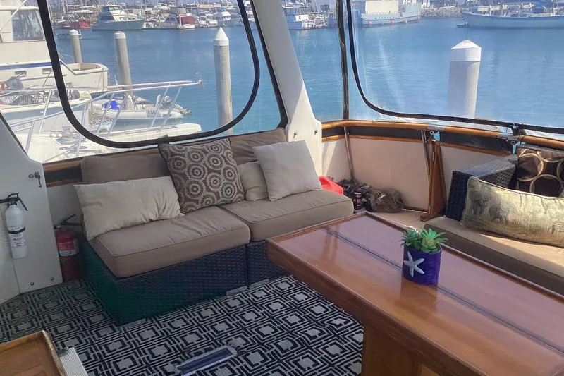 No Reservations Yacht Photos Pics Interior of 1984 Spindrift 52 Motor Yacht with cozy seating and marina view.