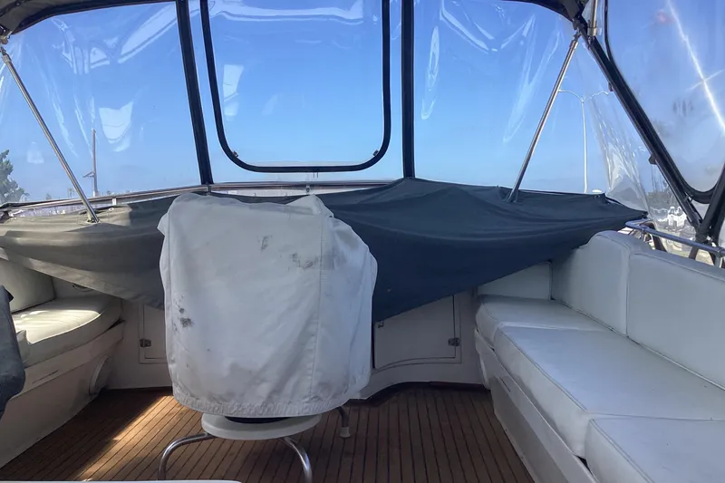 No Reservations Yacht Photos Pics Interior of 1984 Spindrift 52 Motor Yacht with white seating and clear canopy.