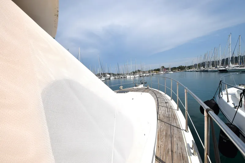Odyssey Yacht Photos Pics Trader Sunliner 625 yacht deck view in marina, 2000 model, with clear sky and moored boats.
