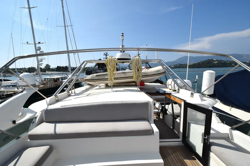 Odyssey Yacht Photos Pics 2000 Trader Sunliner 625 yacht docked at marina, featuring spacious deck and scenic views.