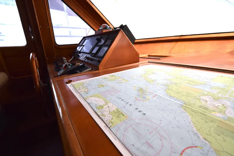 Odyssey Yacht Photos Pics Cockpit of 2000 Trader Sunliner 625 with navigation map and control panel.