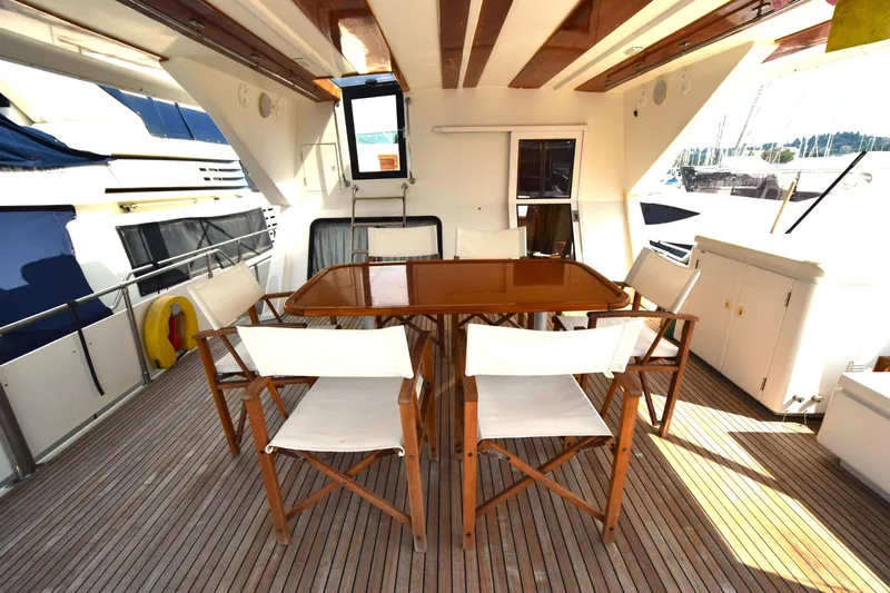 Odyssey Yacht Photos Pics Spacious deck of 2000 Trader Sunliner 625 yacht with wooden dining set.
