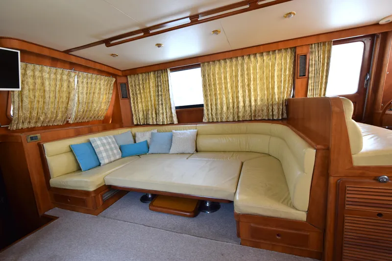 Odyssey Yacht Photos Pics Luxurious interior of 2000 Trader Sunliner 625 yacht with cozy seating and elegant decor.