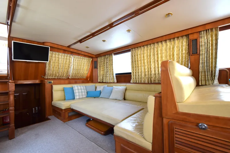 Odyssey Yacht Photos Pics Luxurious interior of 2000 Trader Sunliner 625 yacht with plush seating and TV.