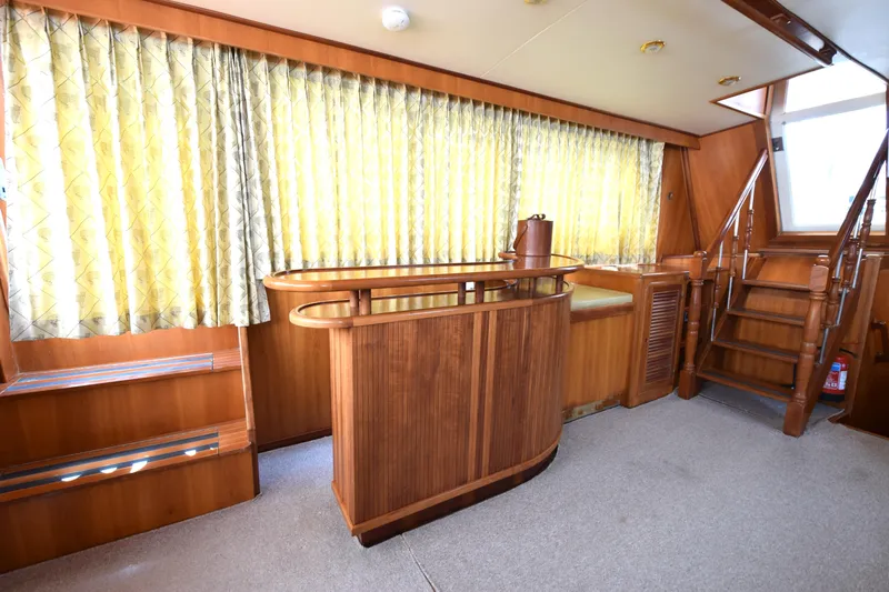 Odyssey Yacht Photos Pics Interior of 2000 Trader Sunliner 625 yacht with wooden bar and staircase.