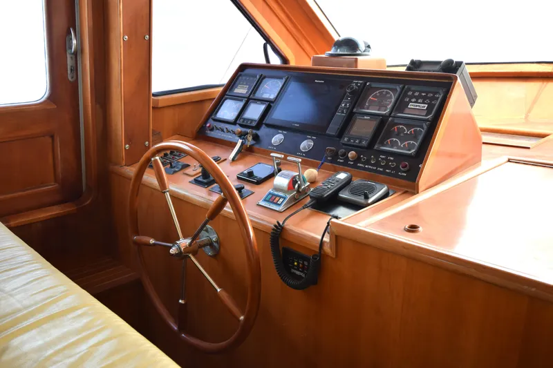 Odyssey Yacht Photos Pics Cockpit of 2000 Trader Sunliner 625 yacht with wooden steering wheel and navigation instruments.
